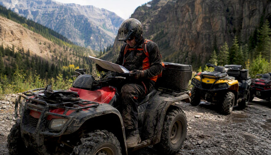 Rider on Honda ATV outdoors in forest trail