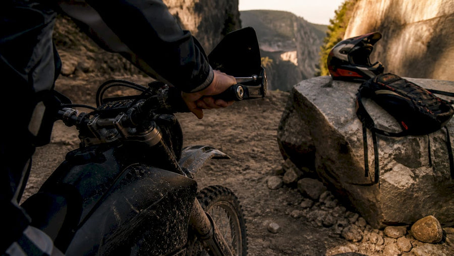 Rider adjusting gear on off-road motorcycle