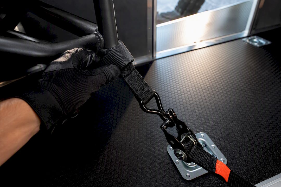Ratchet strap secured around an ATV frame