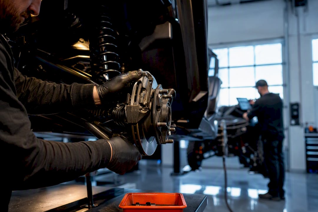 Technician inspecting powersports vehicle repair