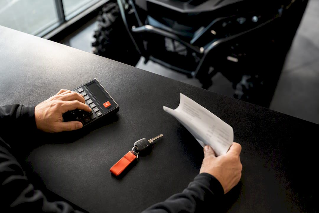 Hands reviewing an ATV pricing quote