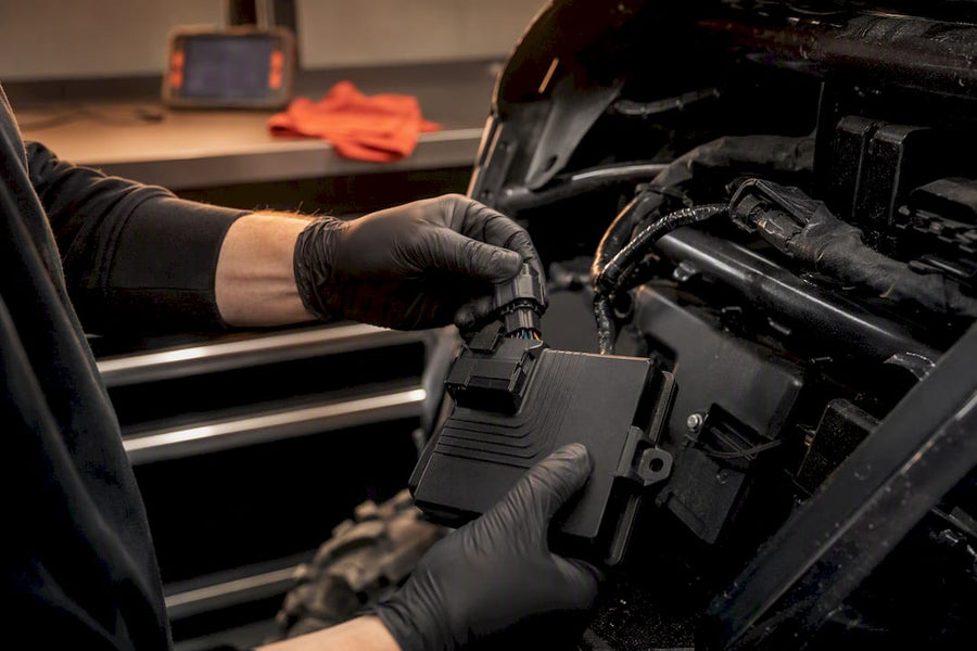 Technician reconnecting an anonymous ECU module