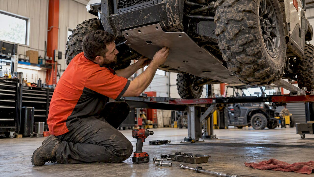 Installer checking a UTV skid plate fit